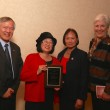 Emily Murase (right) accepts award for her father