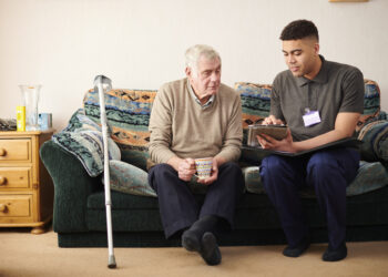 senior man with care worker at home